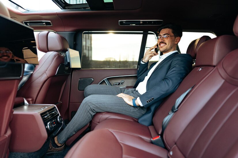 young-businessman-suit-glasses-sitting-passenger-seat-luxury-car_93675-178611